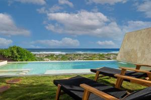 a swimming pool with a view of the ocean at Oceanview villa 4BR Concierge Service in Tulum