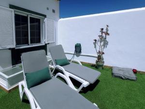 two chairs and a table on a patio at Live Abades Playa y terraza in Abades