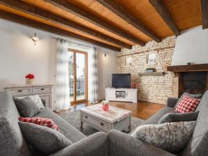 a living room with two couches and a tv at Villa in Sveti Lovrec near Ski Resort in Radetići