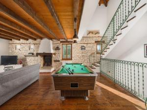 a pool table in a room with a staircase at Villa in Sveti Lovrec near Ski Resort in Radetići