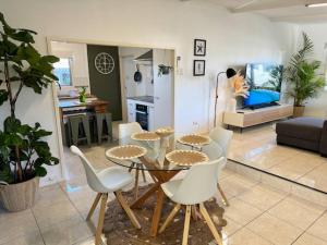 a kitchen and living room with a table and chairs at Golden Sand Bars - Family Beach Escape in Golden Beach