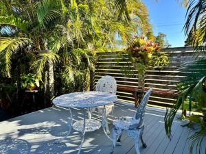a table and two chairs sitting on a deck at Golden Sand Bars - Family Beach Escape in Golden Beach