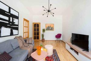 a living room with a couch and a tv at Modern Condo in the City Center in Yerevan