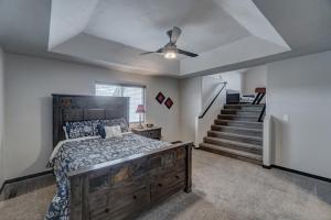 a bedroom with a bed and a ceiling fan at Executive Golf Club Red Rocks Home, Locally Owned! in Rapid City