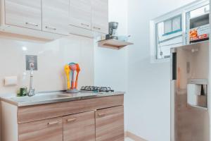a kitchen with a sink and a refrigerator at APARTAHOTEL BEIRUT INN in San Andrés +35 photos