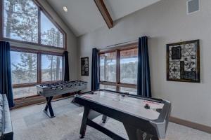 a game room with two pool tables and windows at Black Hills Nature Retreat, Centrally Located in Keystone