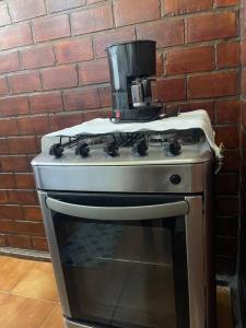 a coffee maker sitting on top of a stove at Condomínio Perto da Praia in Cabo Frio