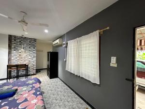 a bedroom with a purple bed and a window at Bangtao Kitchen Studio in Bang Tao Beach