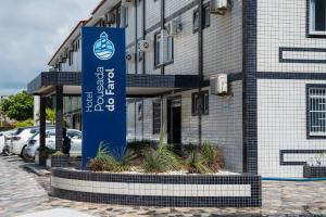 a blue sign in front of a building at Hotel Pousada do Farol in Aracaju