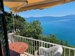 a balcony with a table and a view of the ocean at Apartments by the sea Podaca, Makarska - 19078 in Podaca