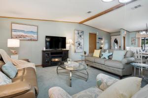 a living room with a couch and a tv at Lake Accessible Family Home On Canal in Okeechobee