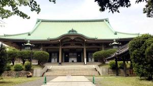 an asian building with a green roof and stairs at Toyoko Inn Yokohama Tsurumi eki Higashi guchi in Yokohama
