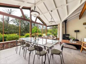 a dining room with a glass table and chairs at Shawlilly Stay in Margaret River Town