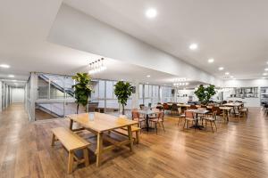 a dining room with tables and chairs in a building at YHA Sydney Harbour in Sydney