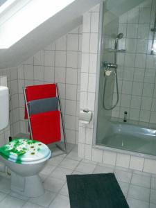 a bathroom with a toilet and a bath tub at Ferienwohnung Kleiner Esch in Bad Zwischenahn