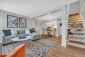 a living room with a couch and a table at Renovated townhome on bike path includes bikes in Decatur