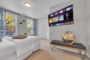a bedroom with a bed and a tv on the wall at Renovated townhome on bike path includes bikes in Decatur