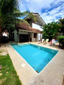 a swimming pool in front of a house at Beach house between Tamarindo and Avellanas in Santa Cruz
