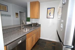 a kitchen with a sink and a refrigerator at Summit 285 1 bedroom 1 bathroom - Pet Friendly in Mammoth Lakes +4 photos