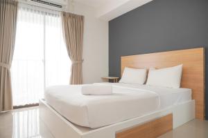 Ένα ή περισσότερα κρεβάτια σε δωμάτιο στο Good Choice Studio Apartment Anwa Residence Bintaro By Travelio +11 φωτογραφίες