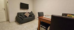 a living room with a couch and a table at Edificio-Pellegrini in Bragado