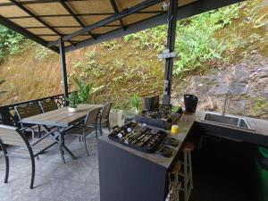 an outdoor kitchen with a sink and a table at Villa Tranquility - Ultimate Estate in Ban Bang Bao