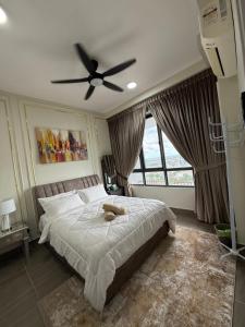 a bedroom with a large bed with a ceiling fan at Troika Kota Bharu by Tasra Homestay with Free CarPark ACCEPT MALAYSIAN ONLY in Kota Bharu