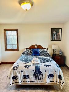 a bedroom with a bed with a blue and white comforter at Affordable Luxury Mansion in Quincy