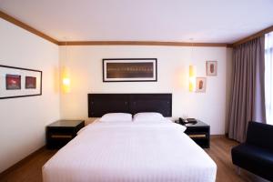 Postel nebo postele na pokoji v ubytování The Tarntawan Hotel Surawong Bangkok