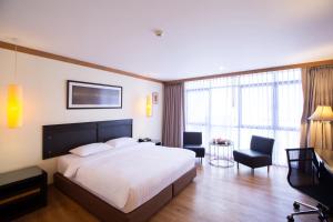 Postel nebo postele na pokoji v ubytování The Tarntawan Hotel Surawong Bangkok