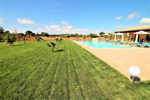 a swimming pool with a white balloon in the grass at Ferienhaus Son Pieres Nou in Llucmajor