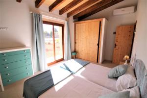 a bedroom with a large bed and a window at Ferienhaus Son Pieres Nou in Llucmajor +32 photos