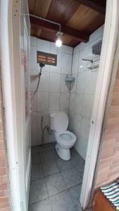 a small bathroom with a toilet in a room at Sandyakala Borobudur in Magelang