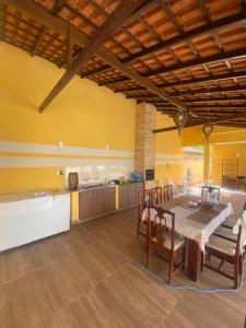 a kitchen with a table and chairs in a room at Casa Amarilla Alter in Alter do Chao