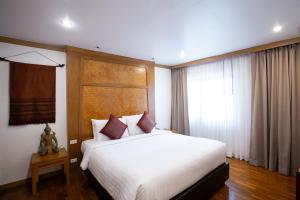Postel nebo postele na pokoji v ubytování The Tarntawan Hotel Surawong Bangkok