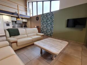 a living room with a couch and a table at Gîte confortable à Athienville - FR-1-584-359 in Athienville