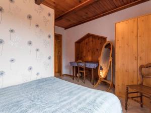 a bedroom with a bed and a desk and a table at Chambres avec salle d'eau privative, petit-déjeuner et terrasse à Melin - FR-1-583-289 in Melin