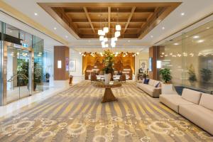 a lobby of a hotel with a couch and a table at Pullman Reef Hotel Casino in Cairns