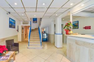 a lobby with a blue staircase in a hospital at Hotel Provencal in Saint-Raphaël