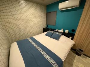 Postel nebo postele na pokoji v ubytování Hotel RIO新宿