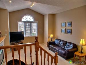 a living room with a leather couch and a television at HB Guest Home in Waterloo