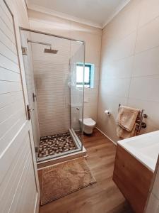 a bathroom with a glass shower with a toilet at Witsand Whalecliff accommodation in Witsand +23 photos