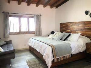 a bedroom with a large bed with a wooden headboard at Villa San Juan Bed&Breakfast in Nuevo Vallarta  +74 photos