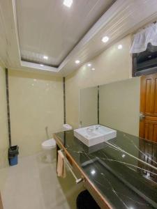 a bathroom with a sink and a toilet at simpang 4 homestay in Tanjungpati