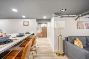 a kitchen and living room with a couch and chairs at Romantic Hideout 1Bedroom Lower Level in Stamford