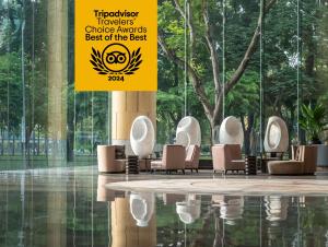 a lobby with chairs and a sign in a building at New World Saigon Hotel in Ho Chi Minh City