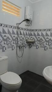 a bathroom with a toilet and a sink at D'Pari Homestay Magelang in Penggaron +10 photos