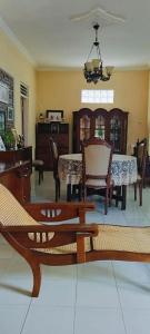 a living room with a table and chairs and a dining room at D'Pari Homestay Magelang in Penggaron