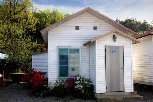 a white house with a door in a yard at Taean Sujung Pension in Taean