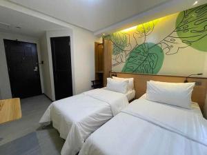 Postel nebo postele na pokoji v ubytování Maharlika City Inn